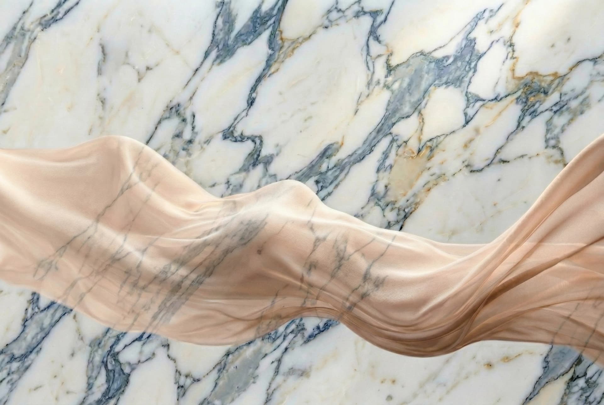 Marble backdrop with flowing silk suggesting elegance, restoration, and refinement